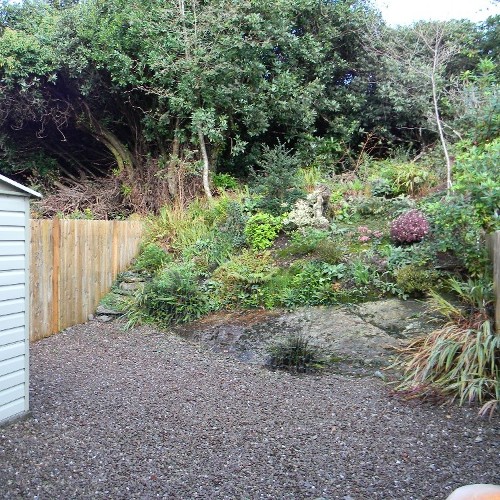 Rear Graveled yard with rockery